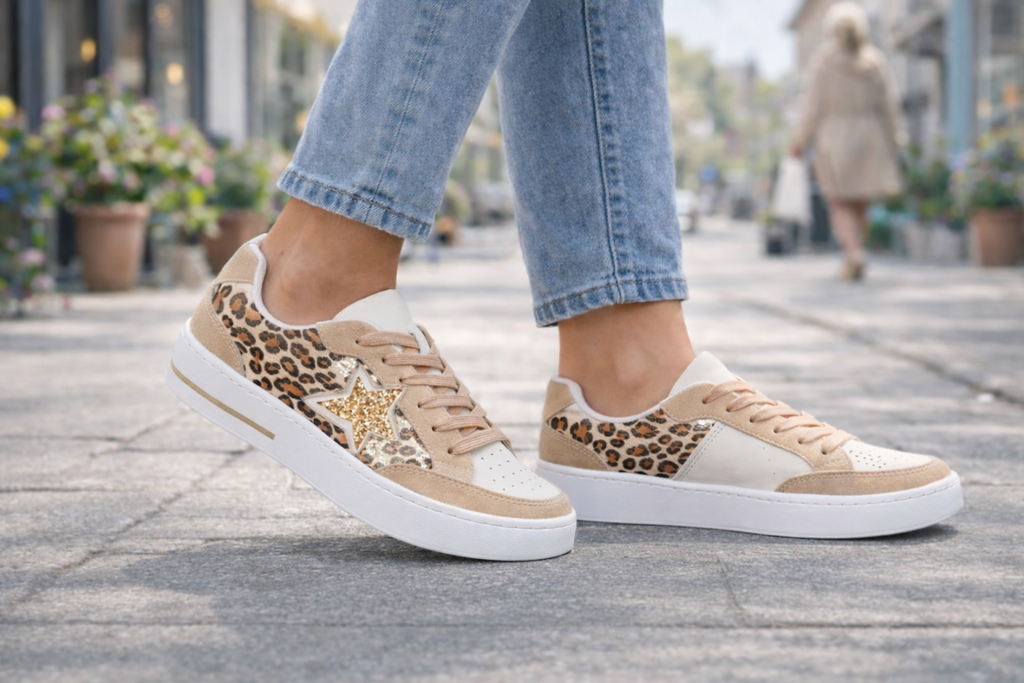 Pair on model part Leopard print trainers worn with light blue jeans. Caracas Shoes by Emma 