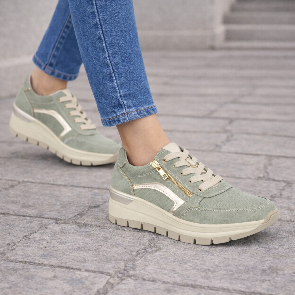 Moss green trainers worn with blue jeans walking outside Dawlish Shoes by Emma 